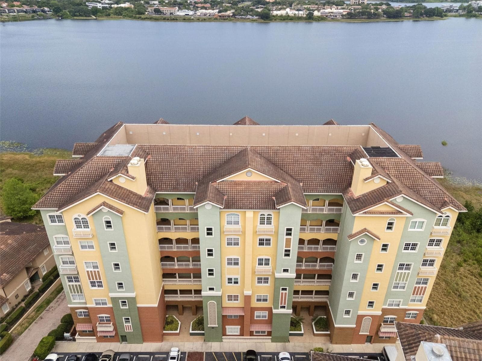 Front exterior of the building with Mediterranean-style architecture — 8743 The Esplanade 34, Orlando, Florida